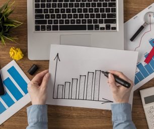 top-view-office-desk-with-calculator-growth-chart